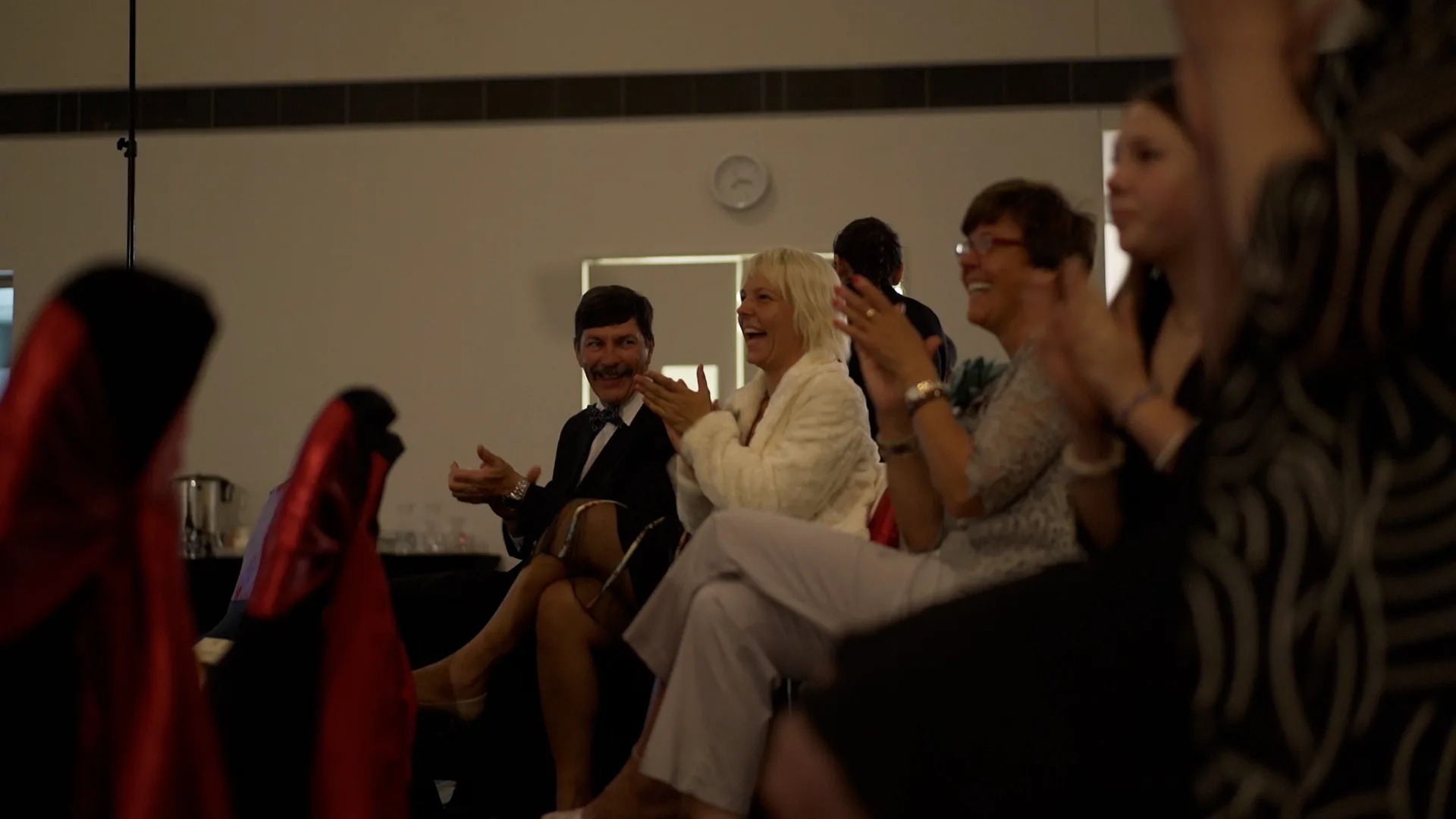 Guests laughing and applauding during the night